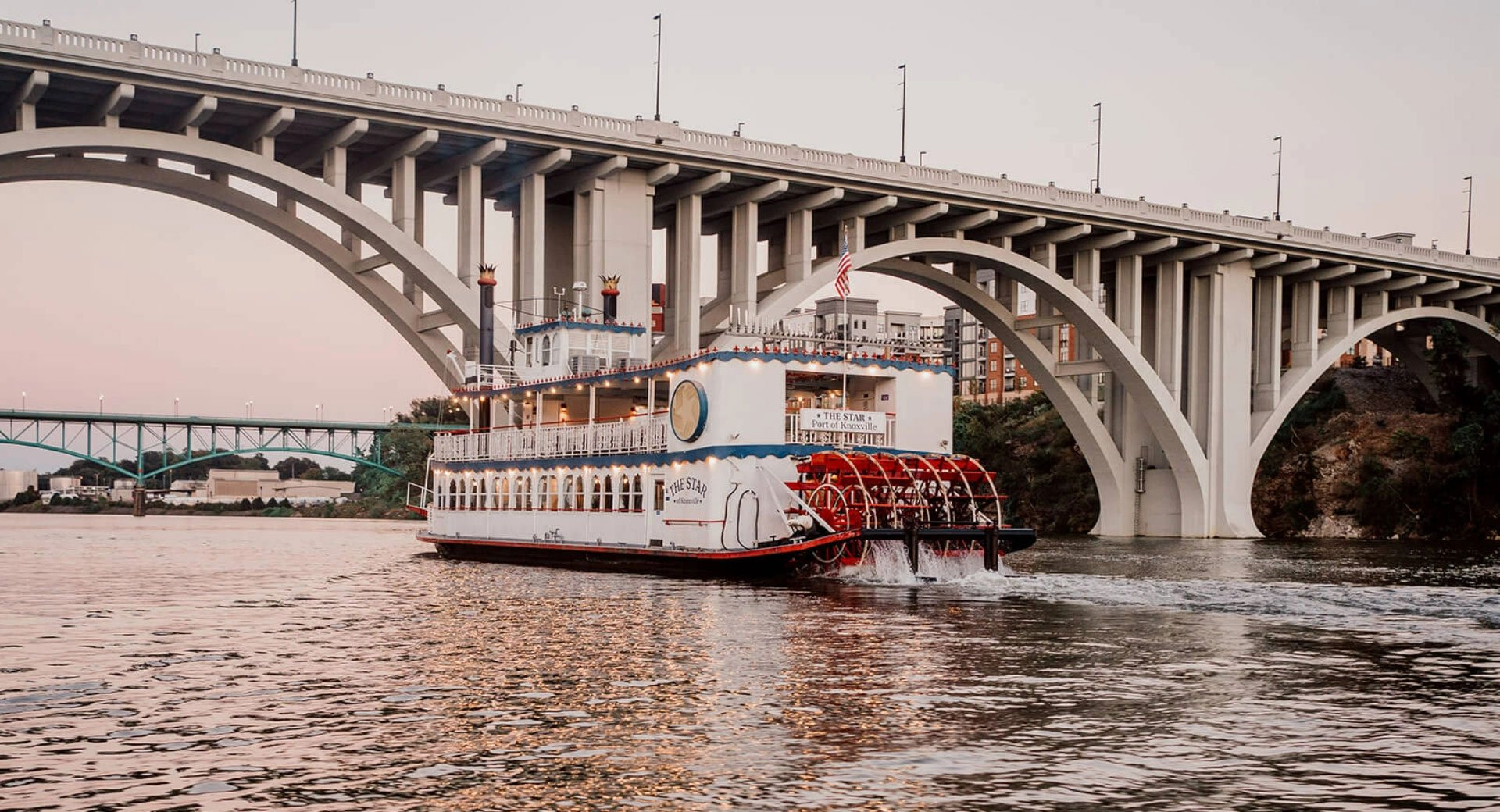 Tennessee River boat with a bridge in foreground