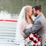 Wedding couple embracing on deck of a boat
