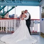Wedding couple kissing on boat deck