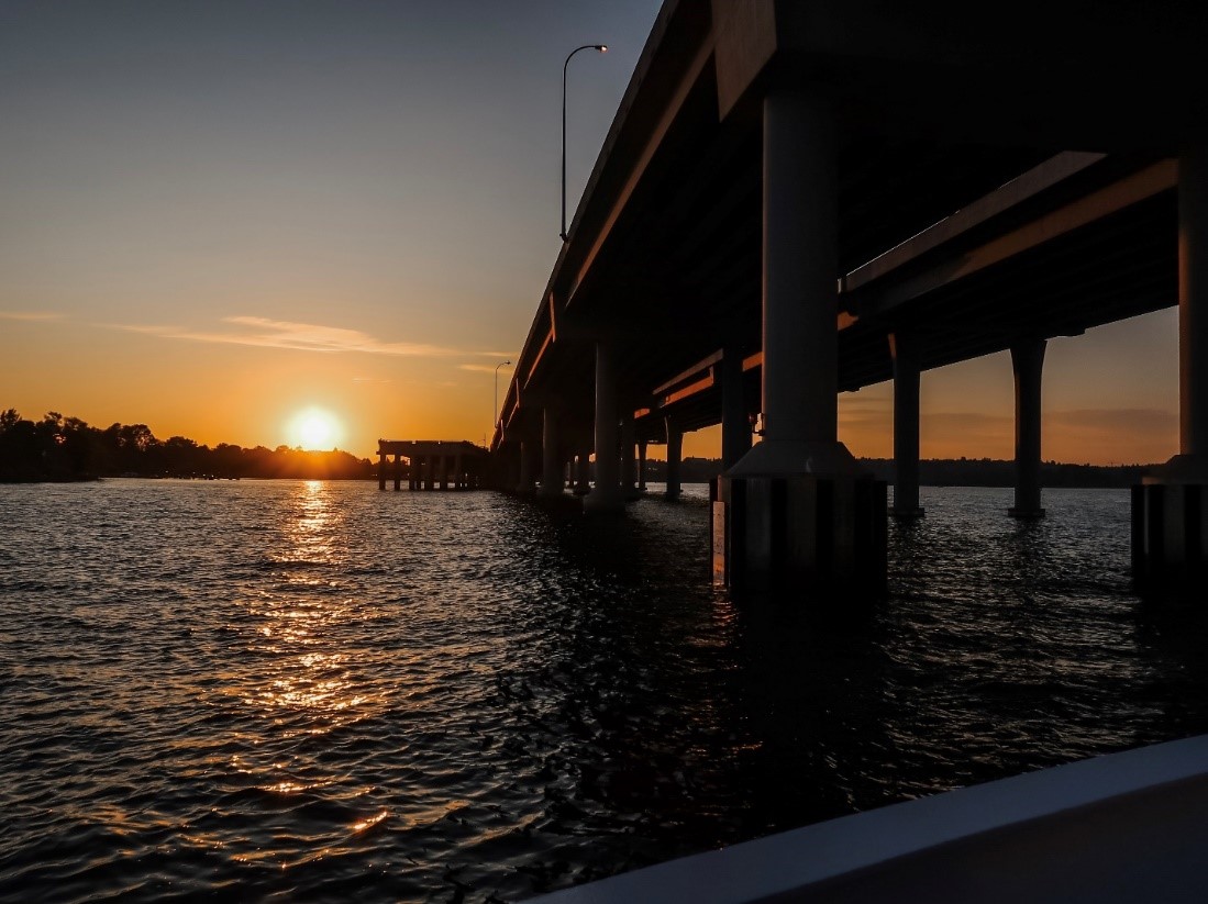 bridge in ocean at sunset