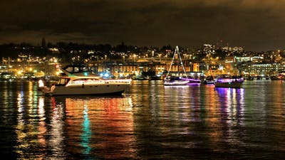 Boat parade of lights at night