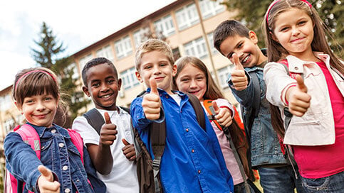 School kids giving thumbs