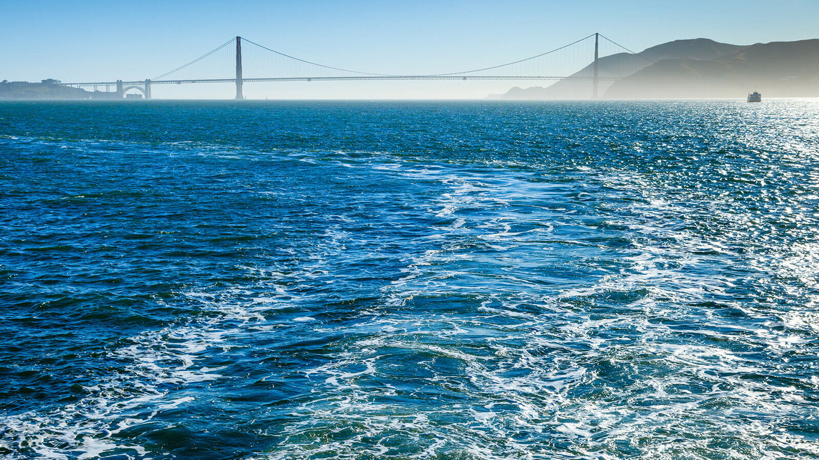Wake of boat with Golden Gate Bridge in background