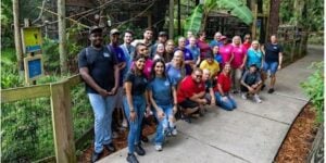 Group of people posing on walk way for botanical habitat