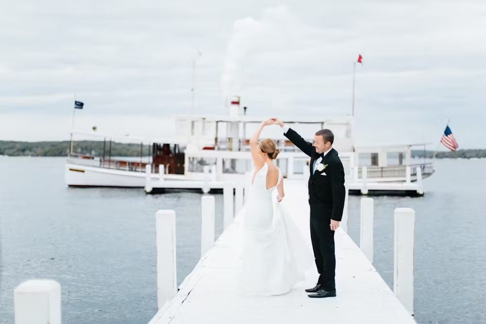 bride and groom on a dock in lake geneva