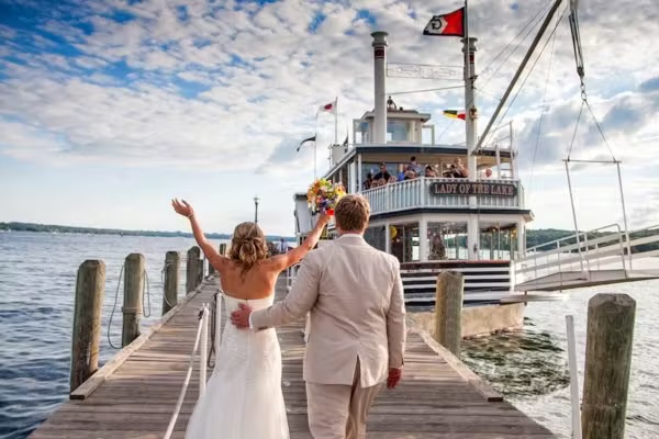 couple getting married in front of boat