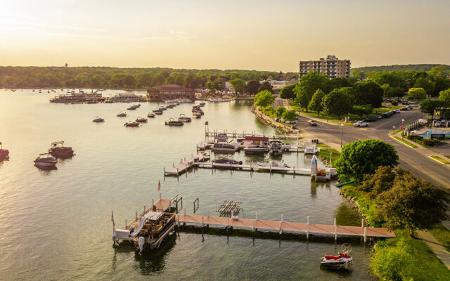 Shore of a lake with moored boats and large docks